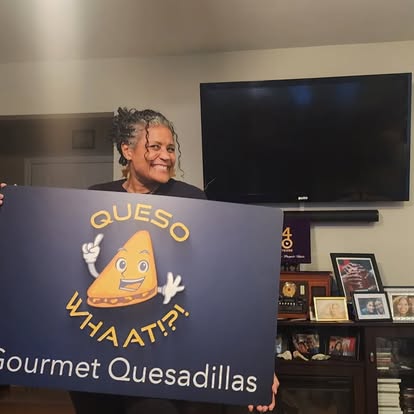 Chef holding the QuesoWhaat!?! sign